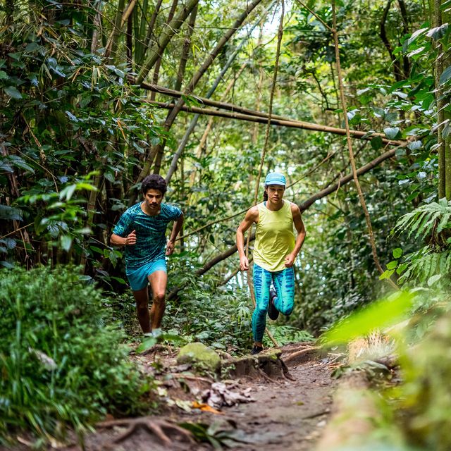 pair of runners running through the wilderness in bright apparel